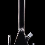 Clear glass bong with downstem and bowl displayed on a black background.