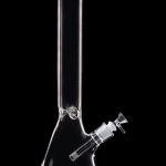 Clear glass bong isolated on a black background.