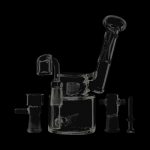 A three-quarter view of the Evolution Morning Glory Sidecar Dab Rig, showcasing its clear glass construction and curved design.