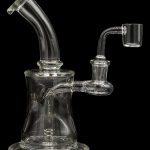 Clear glass dab rig with a bent neck and quartz banger.