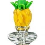 A detailed studio shot of the Pineapple Carb Cap for Puffco Peak, showing its transparent, rounded form and textured surface.