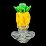 A close-up, angled view of the Pineapple Carb Cap for Puffco Peak, showcasing its textured, translucent glass design.