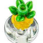A close-up, angled view of the Pineapple Carb Cap for Puffco Peak, showcasing its translucent, colorful design.