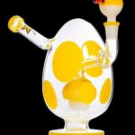 Yellow glass water pipe with polka dot design.