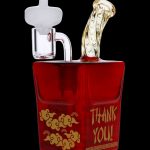 Red glass water pipe shaped like a Chinese takeout container with gold lettering that reads "THANK YOU!".