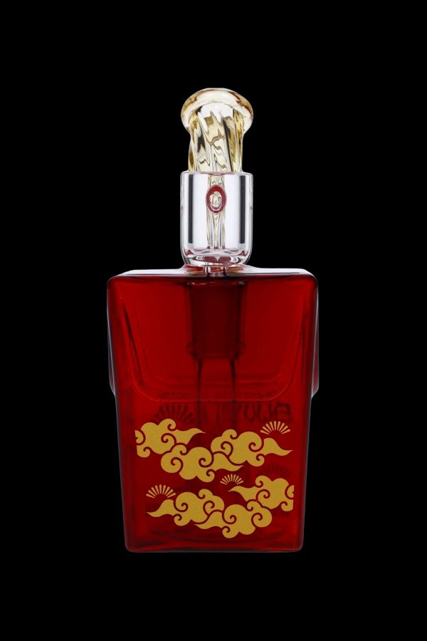 Ornate red glass cannabis oil vial with gold detailing.