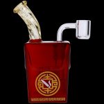 Red glass water pipe with ornate gold detailing and a clear mouthpiece, isolated on a black background.