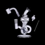 Clear glass dab rig with separate components including a banger, carb cap, and tool, isolated on a black background.