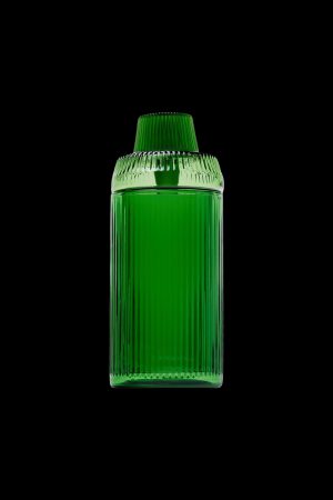 Green glass cannabis oil container on a black background.