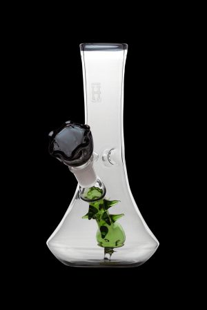 Clear glass bong with green sculpted accents and a black mouthpiece, isolated on a black background.