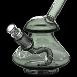 Green glass water pipe with etched mountain and forest landscape design.