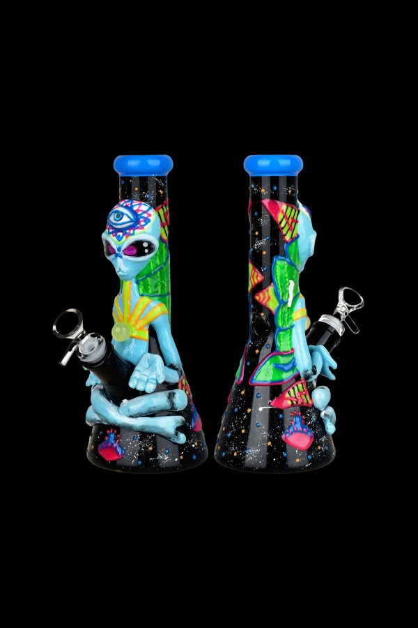 Colorful glass water pipe featuring an alien design, displayed against a black background.