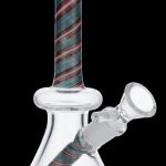 A glass water pipe (bong) with a patterned red, green, and cream colored design."