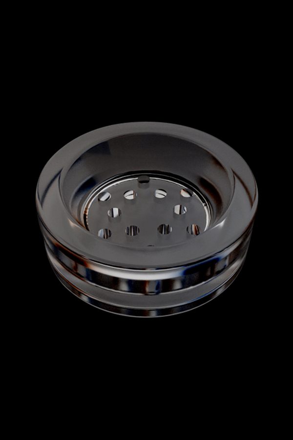 Clear glass dab dish with multiple holes, isolated on black.